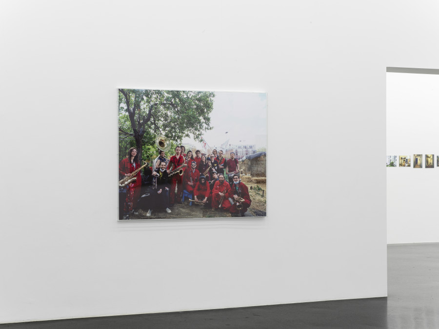 'La Fanfare Climatique' (climate brass band) playing to support the occupancy of the Jardins Ouvriers des Vertus (community gardens) threatened with destruction to allow the building of a swimming pool for the Olympic Games, Aubervilliers, May 8, 2021. Inkjet print (Canson Baryta Photographique paper) mounted on Dibond, Plexiglas box, 126 x 157 x 5 cm, Ed. 1/5 + 2 AP