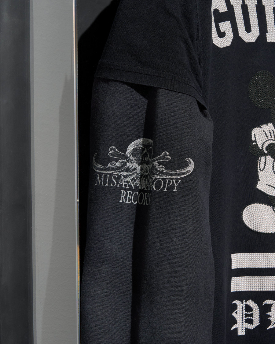 Julian-Jakob Kneer, FANATIC (2) (Detail), 2025, Archival Misanthropy Records hoodie, Philipp Plein x Disney t-shirt, cast rubber and acrylic glas vitrine, 106 x 76 x 22 cm. Courtesy the artist and Blue Velvet, Zurich. Exhibition views by Andrea Luca Ammann.