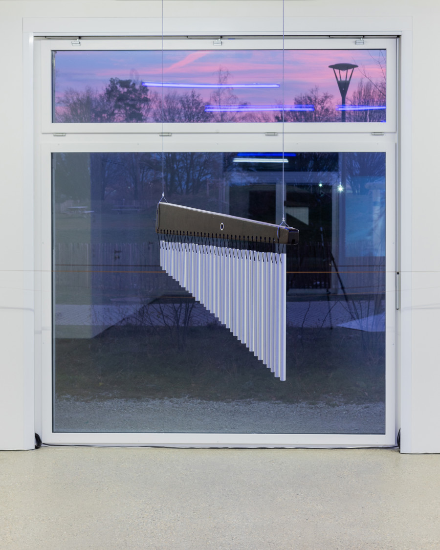 F(r)ictions of Intimacy" exhibition view; Soñ Gweha, RIDING APEX (OASIS VECTORS), video installation, triangular cushion and chime, variable dimensions, 2023 (detail) at CALM - Center d'Art La Meute, Lausanne, Switzerland, 2024 / Curation Caroline Honorien / Photo: Théo Dufloo / Courtesy of the artists and CALM - Centre d'Art La Meute.
