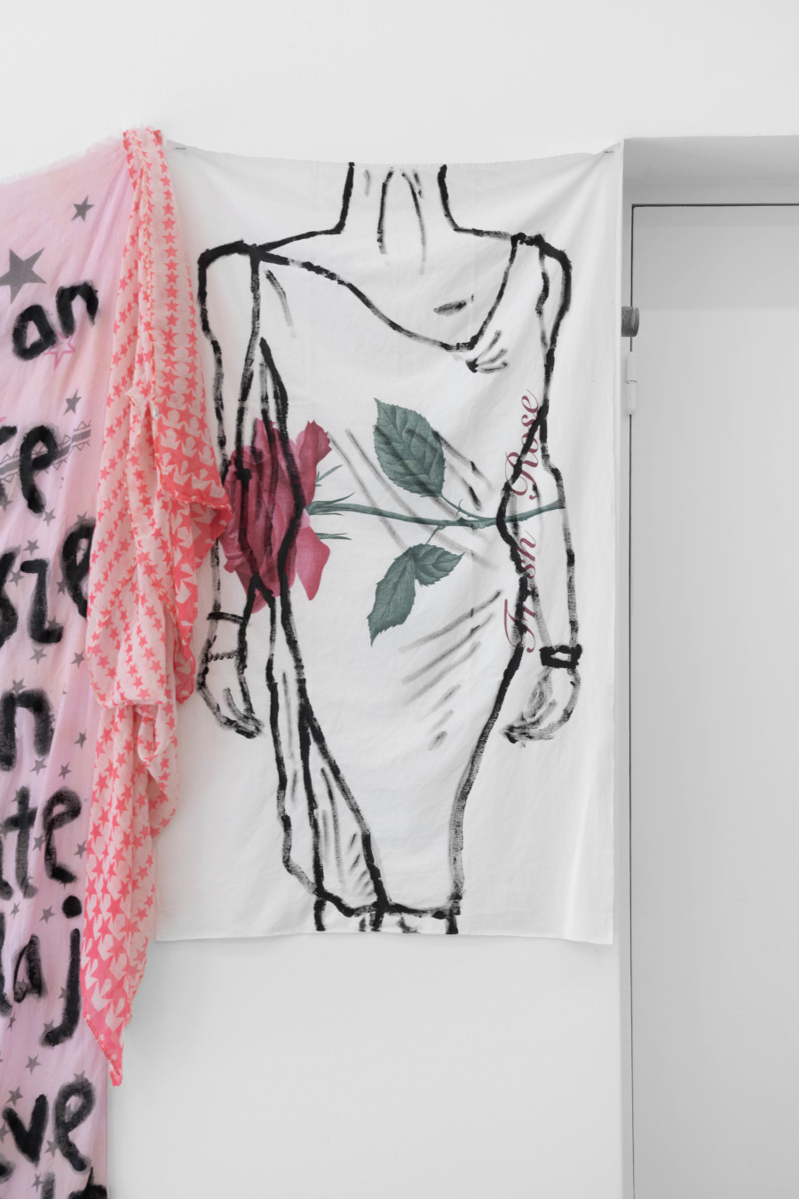 Billy Morgan, Left: Bridges I, 2025, fabric, 118 x 17 cm, Right: Red Letters (Rose), 2025, acrylic on fabric, 103 x 59 cm. Installation view from the solo show Lackadaisies, curated by marytwo, jevouspropose, Zurich, 2025. Courtesy the artist and marytwo. Photo: marytwo, Elvira Baettig