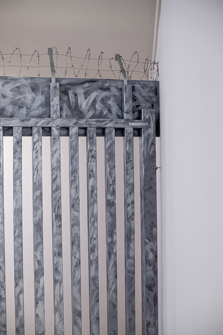 Exhibition View Solo Show Yota Tsotra «Wor(l)ds of borders»; view on Yota Tsotra, Fence, 2025, wood, metal, concrete, acrylic and PU lack, 424 cm x 226 cm x 15 cm» at Peripherie 8, Basel, 2025 / Photo: Stefan Schmidlin / Courtesy: Peripherie 8