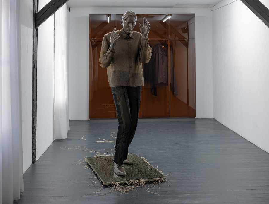 Front: Pascale Birchler, Still Untitled, 2024, iron, modelling clay, glaze, pigments, textile, grass, wood and glass, ca. 215 × 85 × 200 cm. Back: Pascale Birchler, Still Untitled, 2024, wood, acrylic glass, textile, 260 × 250 × 40 cm. Photo by Bon Wongwannawat. Courtesy of the artist and Last Tango
