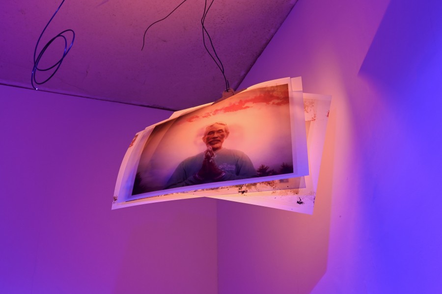 "Who Wrote the Book of Dub?," 2005/2024, print on neon orange paper, photo print on pergament paper, wire, lamps, dimensions variable. "Shi Deh Deh" by Jasmine Tutum at Kaiserwache, Freiburg im Breisgau, 2026. Photo by Stefan Lux.