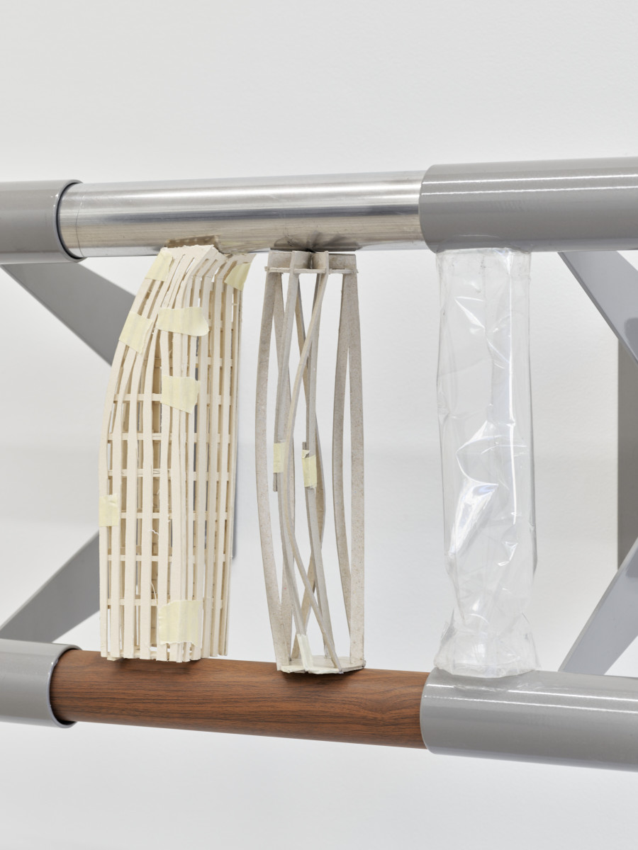 Christiane Blattmann, Dependers, 2025, Barre holders, aluminum, cardboard, archival polypropylene, 29 × 59 × 31 cm. Damien & The Love Guru, 2025. Courtesy of the artist and Damien & The Love Guru, Brussels/Zurich. Photography : Felix Jungo