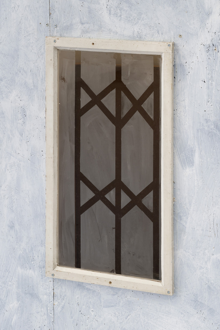 Detail of Aldo Mozzini, Quasi un rifugio, 2025. Drawing, large poster on poster paper, 356 x 504 cm – MDF panels, window with design made with yoghurt, bituminous paper, white wooden flag, stool, lamp, intaglio printing fabrics, plastic waste, various types of wood, 220 x 280 x 140 cm. Ph by Riccardo Giancola. Images courtesy of artists and La Rada, Photography by Riccardo Giancola (@riccardo_giancola) and Emanuele Finardi (@e.m.hey)