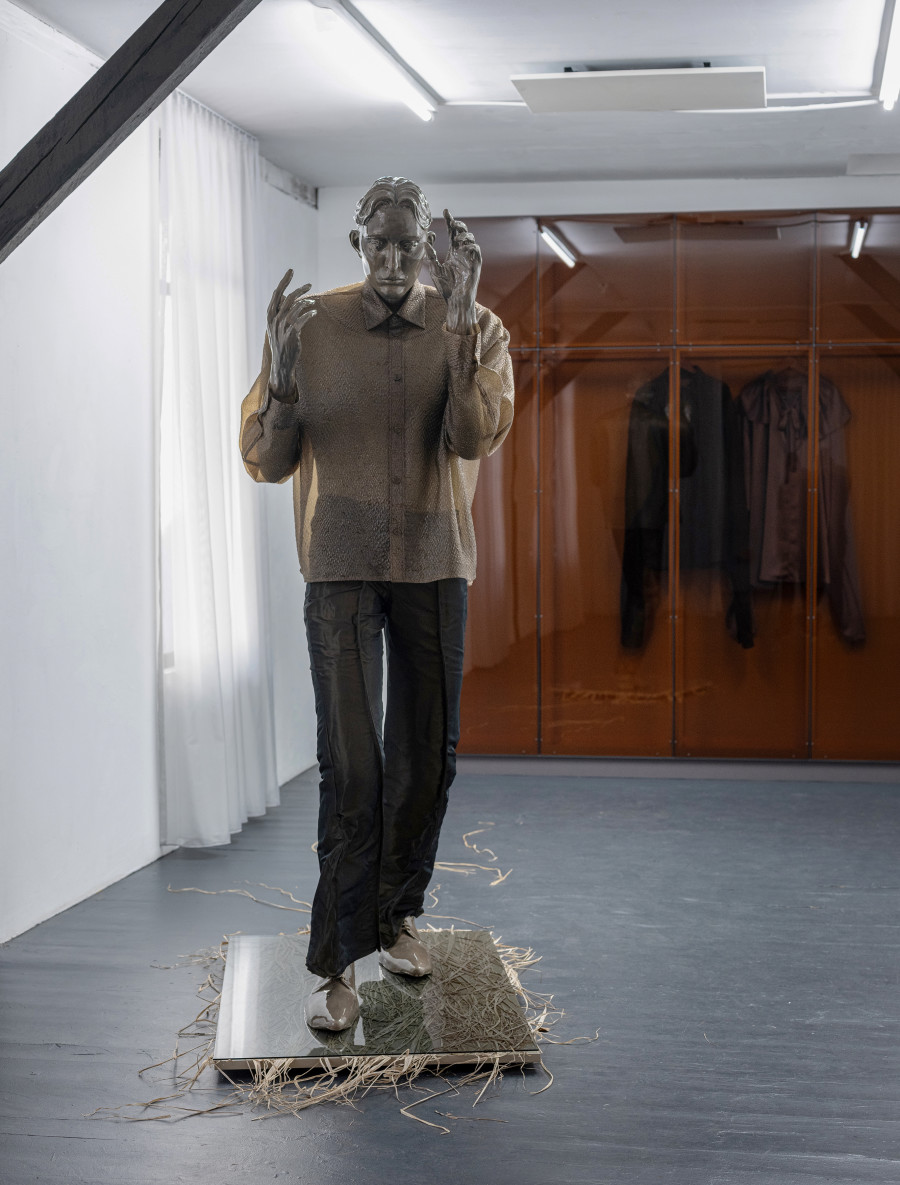 Front: Pascale Birchler, Still Untitled, 2024, iron, modelling clay, glaze, pigments, textile, grass, wood and glass, ca. 215 × 85 × 200 cm. Back: Pascale Birchler, Still Untitled, 2024, wood, acrylic glass, textile, 260 × 250 × 40 cm Photo by Bon Wongwannawat. Courtesy of the artist and Last Tango