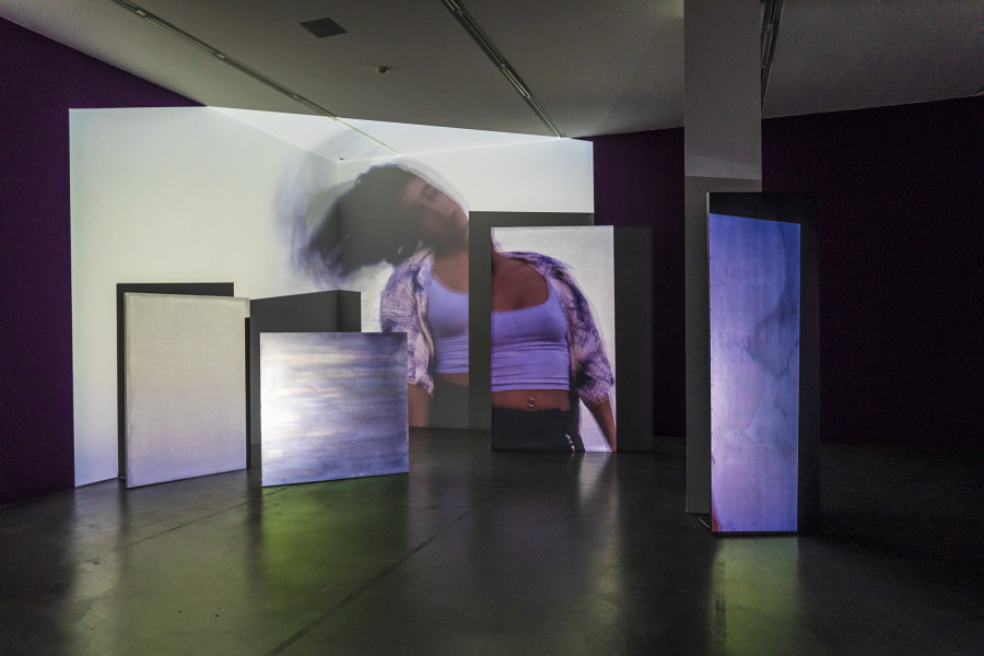 Basel Abbas & Ruanne Abou-Rhame, May amnesia never kiss us on the mouth: Only sounds that tremble through us, 2020 - 2022, 4-channel video projection (HD, color, sound) on partition wall, metal and concrete panels, photographic gel (detail). Performer: Rima Baransi, Haykal, Julmud, Makimakkuk. Courtesy the artist. Co-commissioned by the Museum of Modern Art, New York, and Dia Art Foundation, New York. Photo: Peter Baracchi