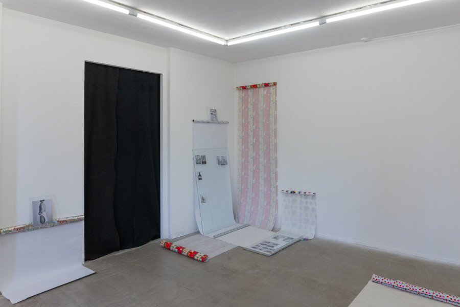 Exhibition view, Sven Gex, celebratory, Halmet, Zürich, 2025. Sven Gex, celebratory, 2025, gift wrapping paper, nails, glass, printed images from the ‚character fitting‘ series 2021-ongoing