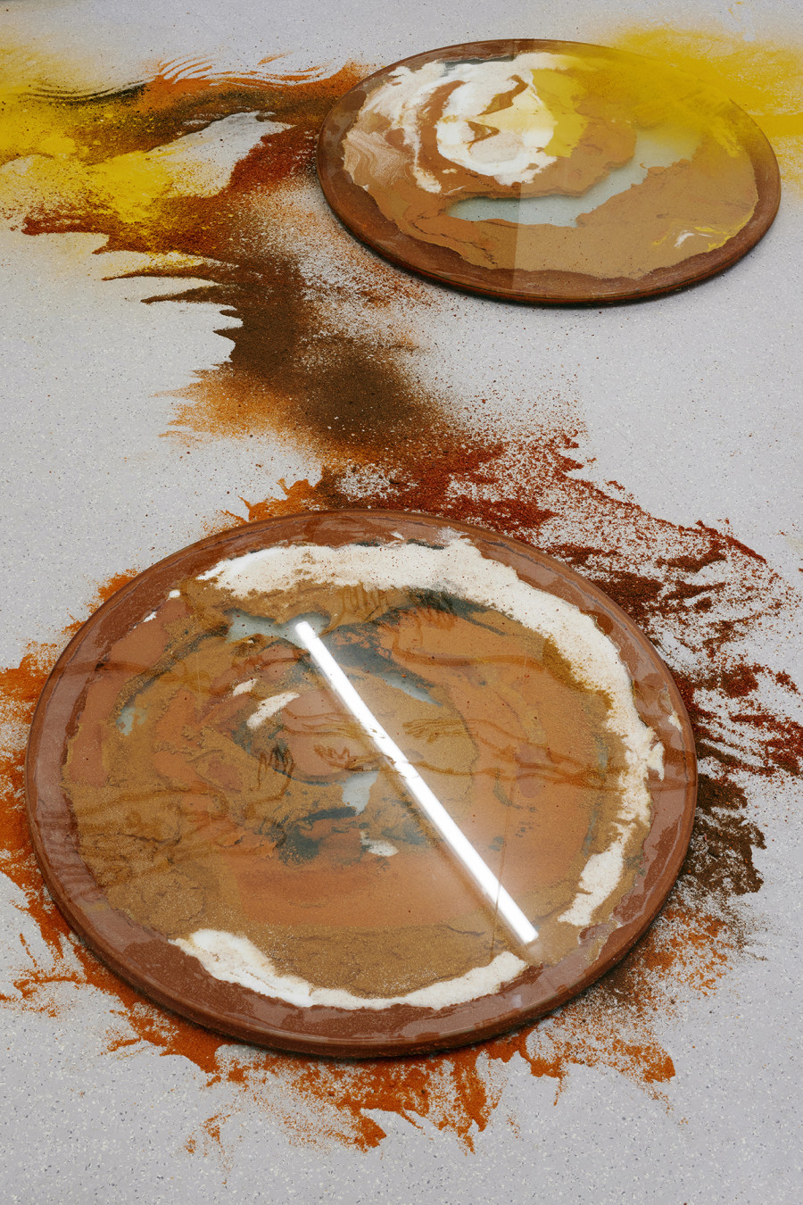 Monia Ben Hamouda, The Luncay of Lunar Sightings (Hourglasses VIII & IX), 2022, Glass, chilli pigmented silicon, spices, 80 x 80 x 3.5 cm, each. Installation view from the solo show The Eye, the Hands, the Lunacy of Lunar Sightings, curated by Anissa Touati, jevouspropose, Zurich, 2022. Courtesy of the artist and ChertLüdde, Berlin, photo: Hannes Heinzer