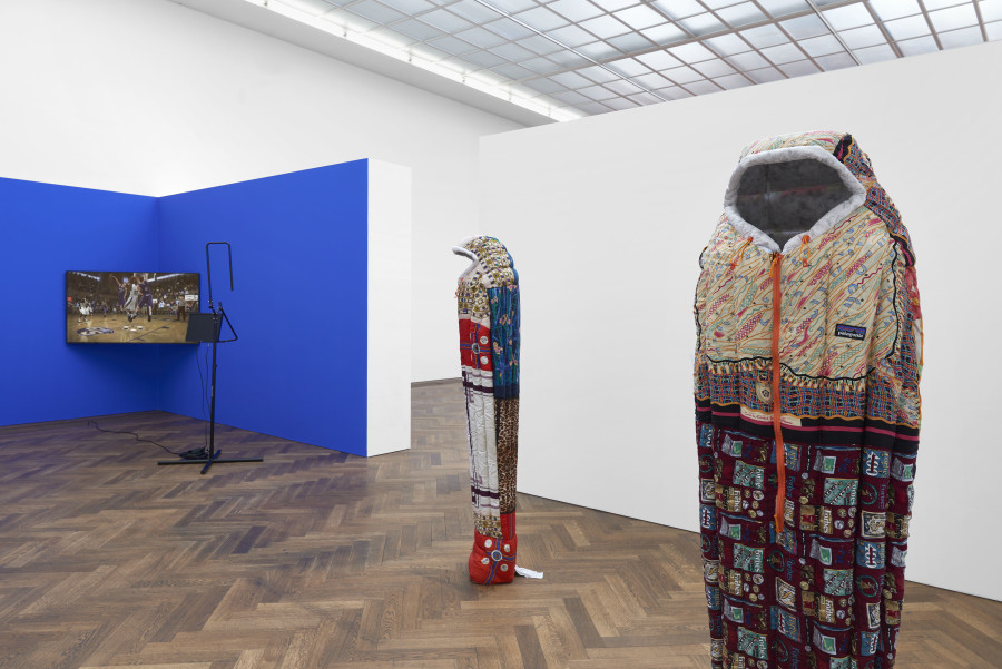 Installation view, INFORMATION (Today), Kunsthalle Basel, 2021, view on Simon Denny, Remainder 1, 2019 (right); Simon Denny, Remainder 2, 2019 (middle); Sondra Perry, IT’S IN THE GAME ‘18 or Mirror Gag for Projection and Three Universal Shot Trainers with Nasal Cavity, Pelvis, and Orbit, 2018 (left). Photo: Philipp Hänger / Kunsthalle Basel