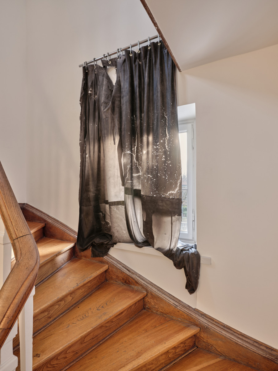Exhibition View, ‘Stitches: A Haunted House and Other Ghost Stories’ at the Villa Bernasconi, 2026 / Photo by Nicolas Delaroche Studio. Li Tavor, Dark Curtains I, II, III, 2025, pigmented latex curtains, aluminum, carabiners